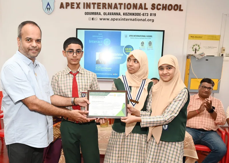 A pupil receiving a certificate at an Apex school presentation