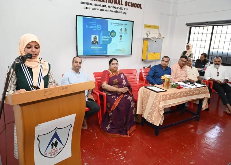 An Apex pupil speaking at a microphone during a school event