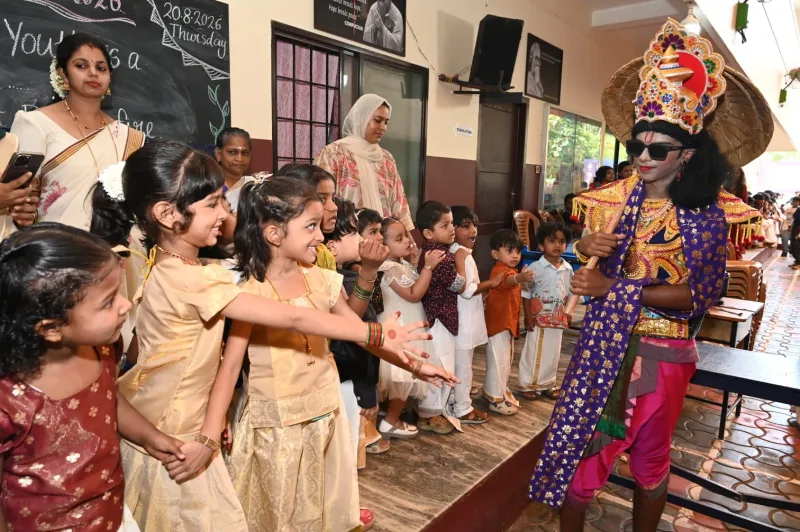 Young Apex pupils in traditional dress greeting Maveli at the school’s Onam celebration